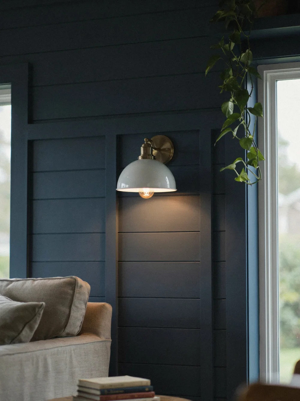 White Enamel Sconces Against Dark Shiplap
